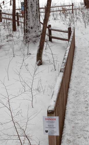 A sign on the path that leads to a cleared spot for skating on Puffer’s Pond on Monday afternoon warns people about the dangers of skating on the pond, and reminds them that they are skating at their own risk. 