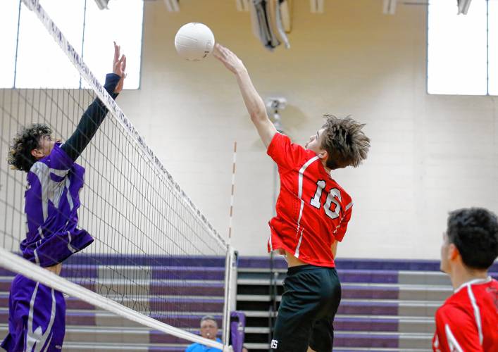 Athol’s Ethan Goodwin (16) tips the ball against Holyoke’s Adrian Centeno-Feliciano (4) in the first set Friday in Holyoke.