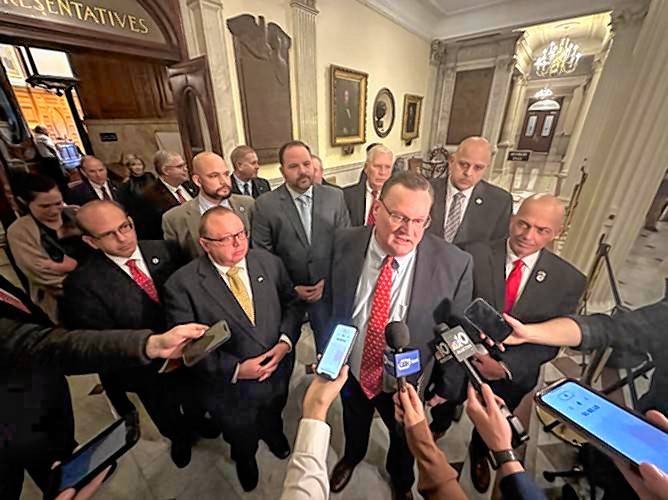 House Minority Leader Bradley Jones Jr. speaks to reporters, backed by much of the House Republican Caucus, after House Democrats mustered a quorum and accepted a conference report on the FY23 closeout budget Monday, Dec. 4. 